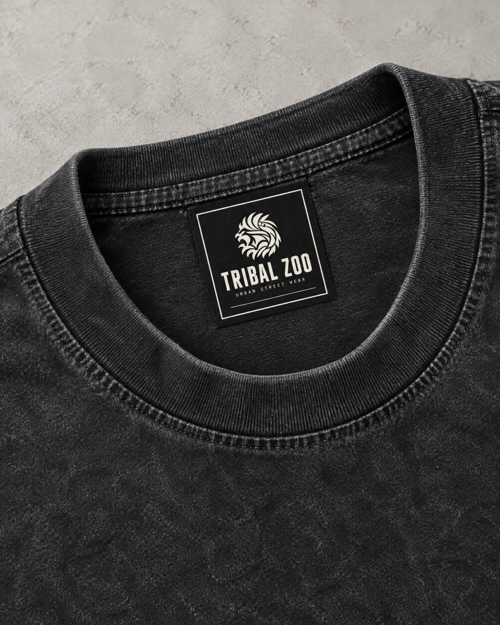 Tribal Zoo woven neck tag on a black mineral-wash T-shirt